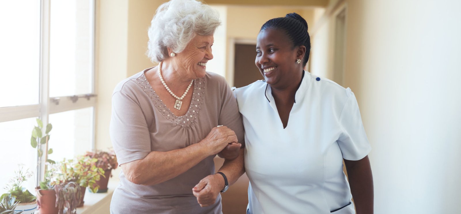 elderly and caregiver smiling