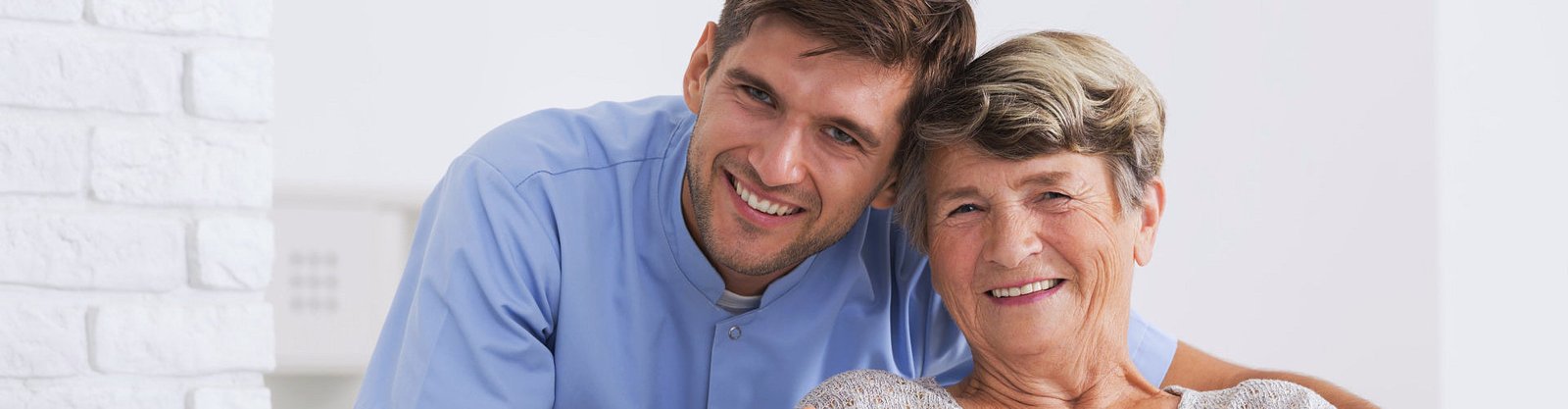 elderly and caregiver smiling