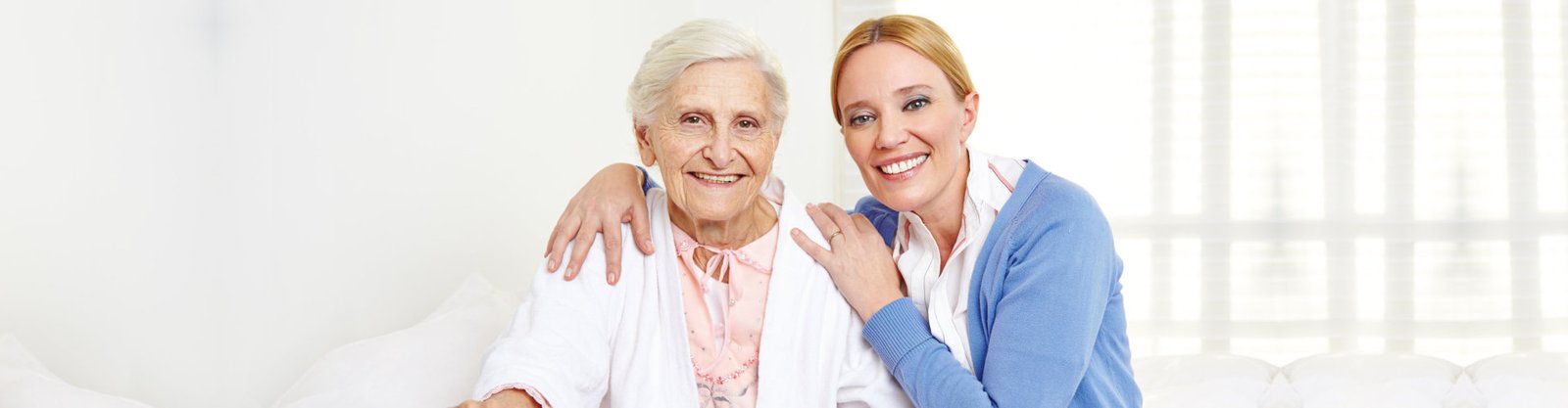 caregiver and elderly smiling