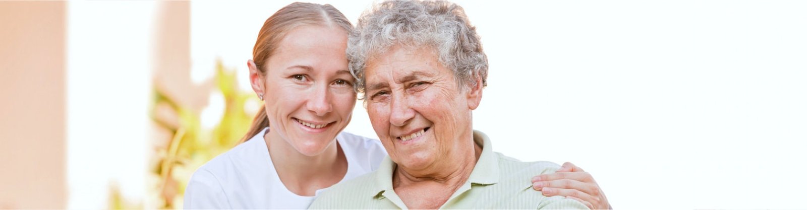 caregiver and elderly smiling