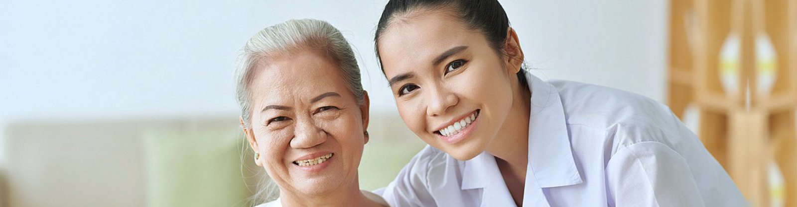 elderly and caregiver smiling